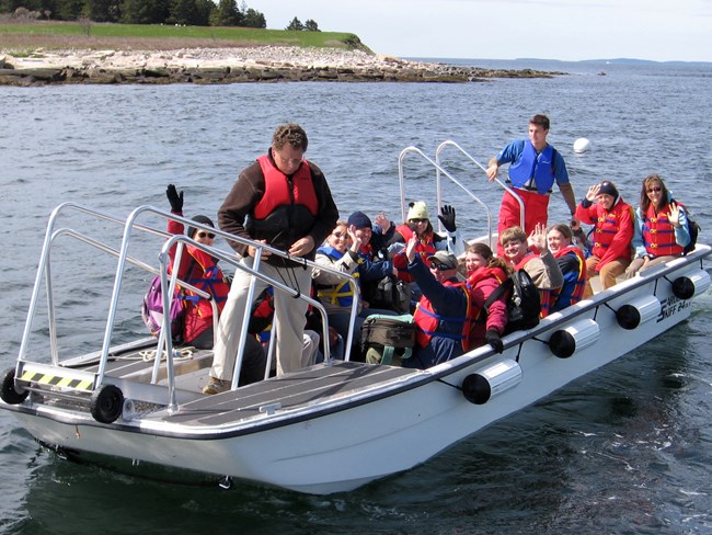 people in life vests on a boat