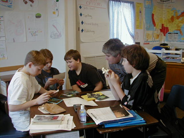 Students looking at program packets with ranger.