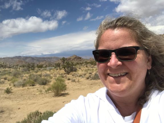 Woman looking at camera with desert in the background