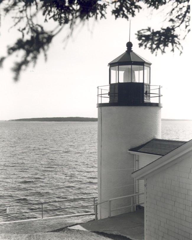 Historic photograph of head light with coast in background