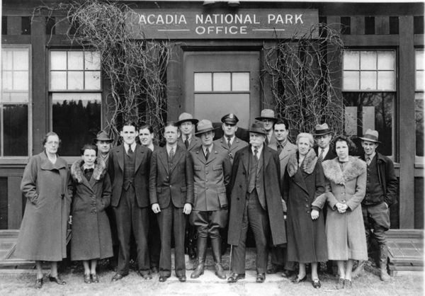 Acadia National Park staff and advisors standing in front of the original park administrative building