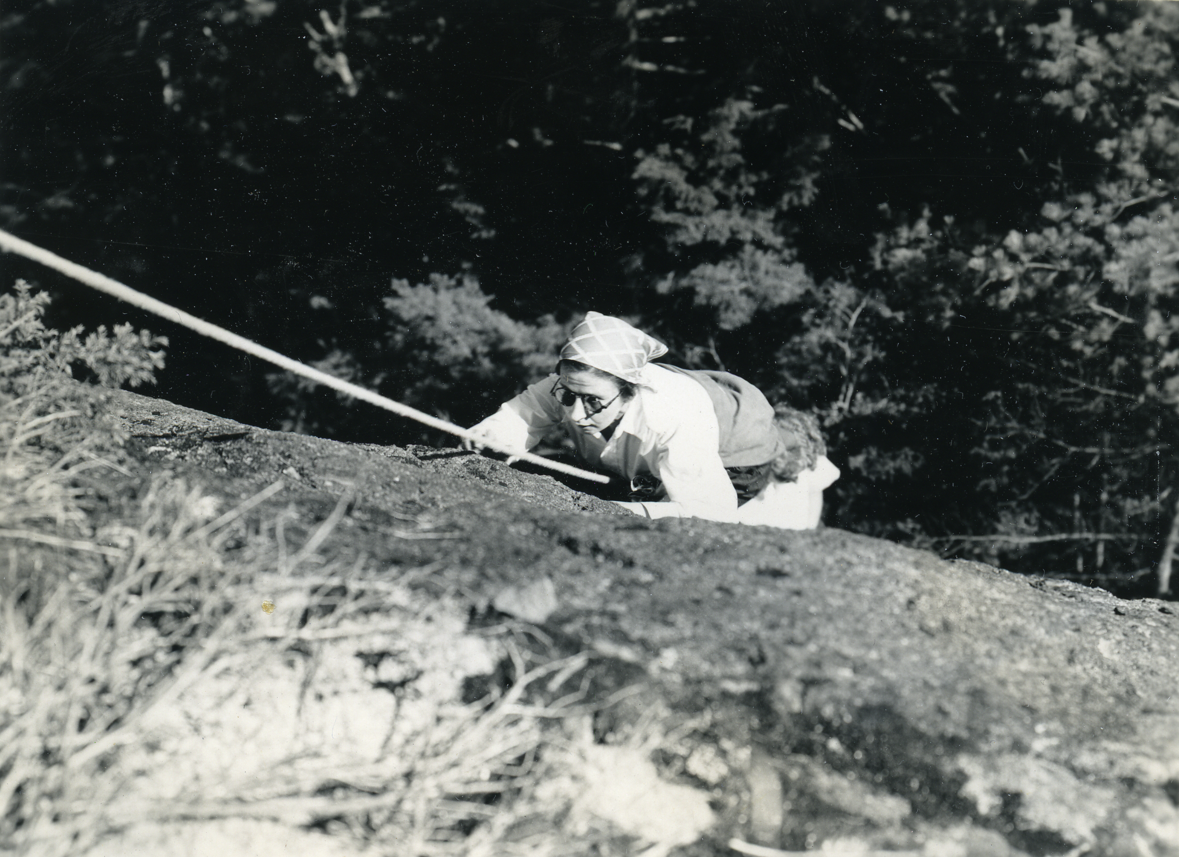 Historic photograph of a woman rock climbing