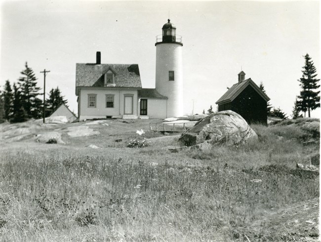Historic photograph of a lighthouse and other buildings