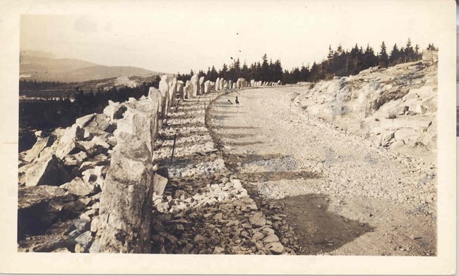 Historic photograph of road construction on a mountain