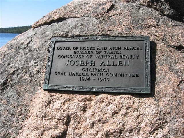 A rectangular bronze plaque on granite