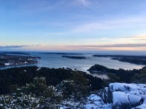 Sunset view of coastline and islands covered in snow