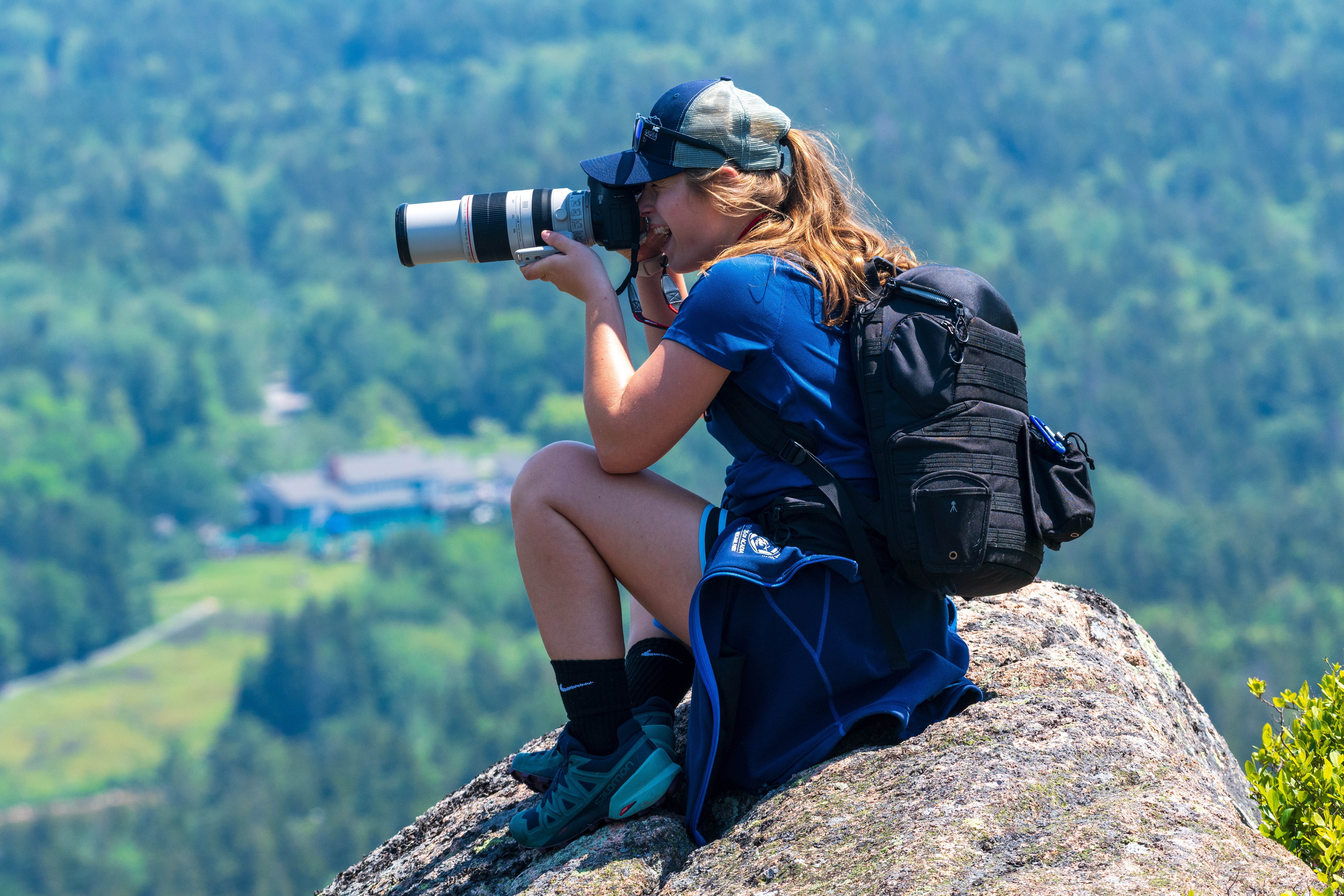 Wildlife photographer taking photos in Acadia National Park with professional camera equipment