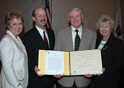 Deputy superintendent is presented award by NPS director and park superintendent.