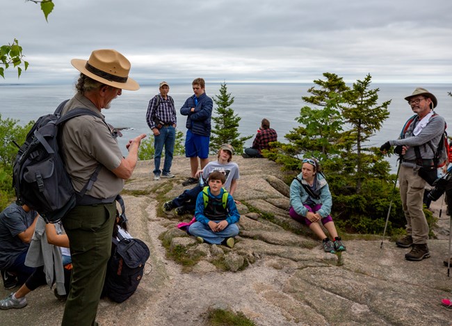 Park ranger leads program on cliffs near ocean