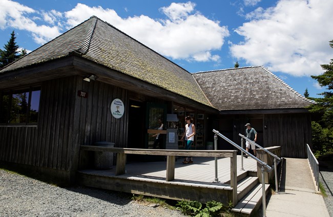 Visitor walking into wooden store building