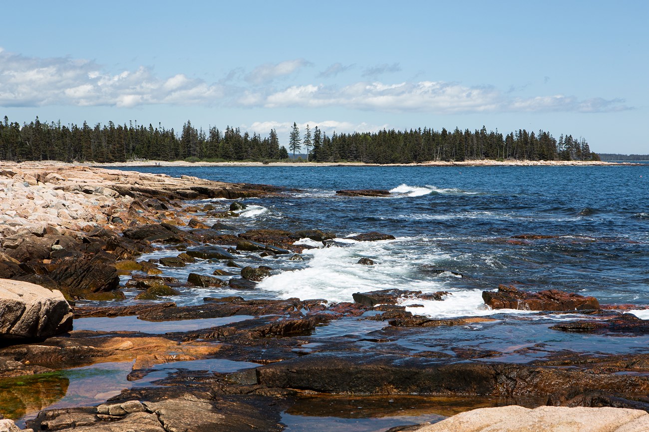 Waves hitting rocks along coastline