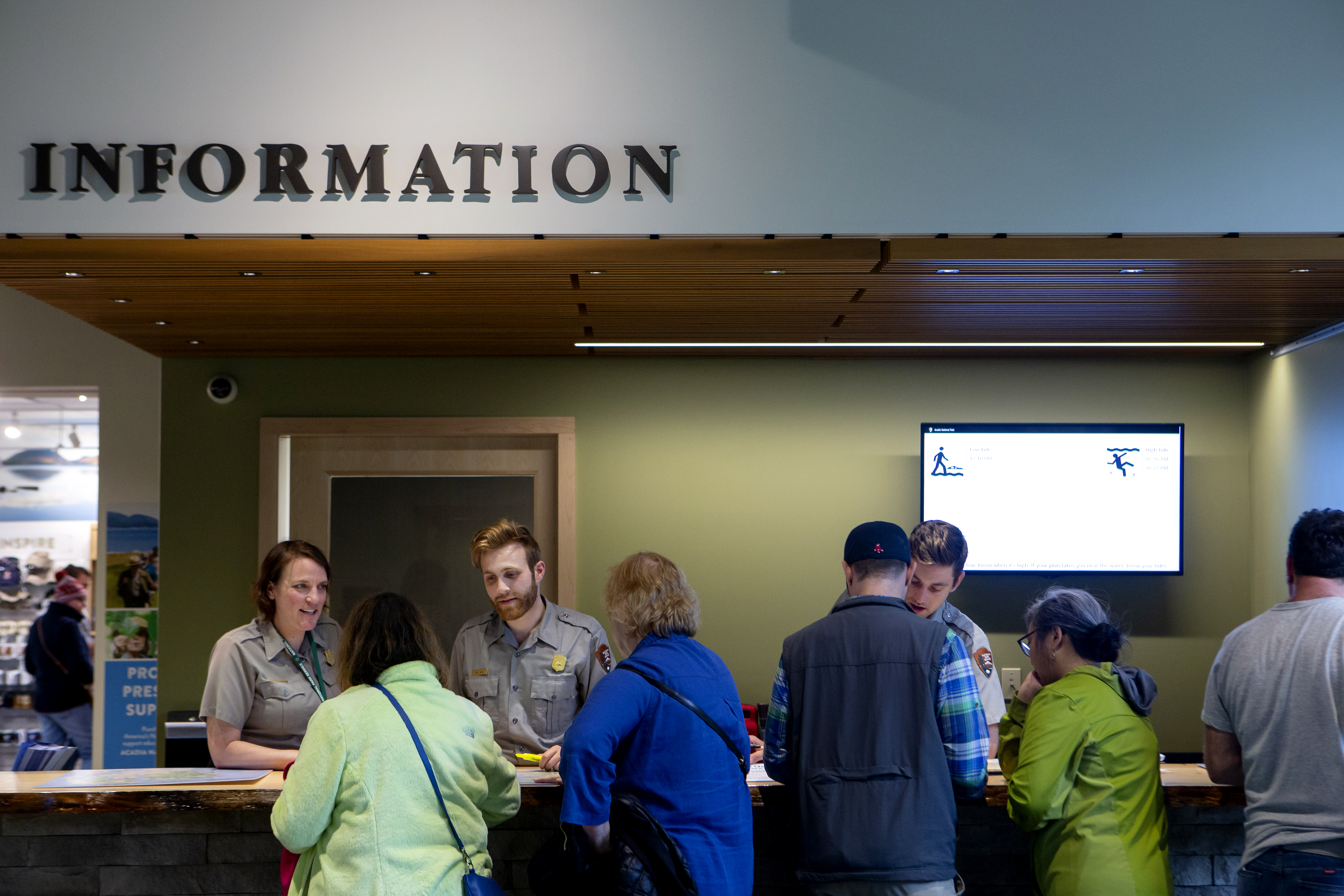 Rangers providing information at Hulls Cove Visitor Center information desk
