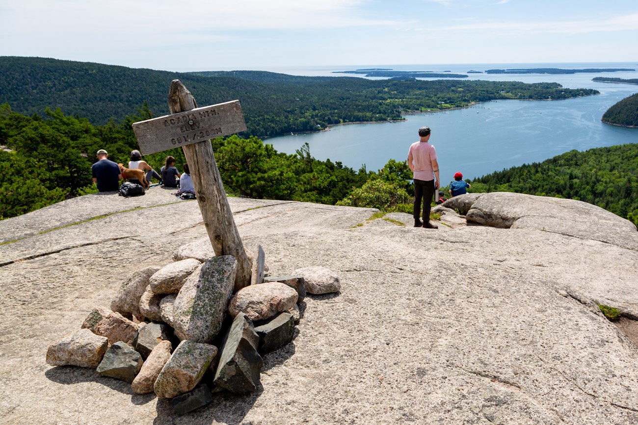 Visitors stand on summit overlooking sound