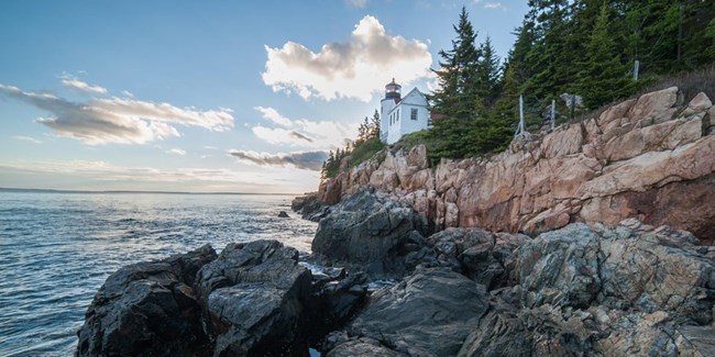 Lighthouse by rocky coastline