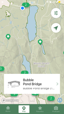 section of park map showing a blue location dot and green waypoint markers