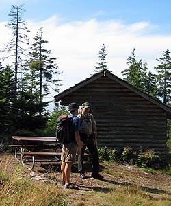 A park ranger meets with a visitor at a campsite on Isle au Haut.