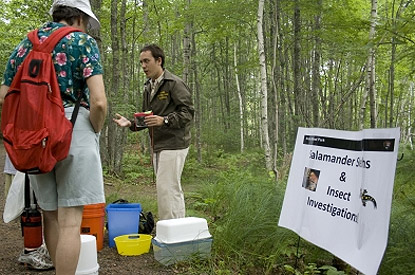 Volunteer talks to visitors