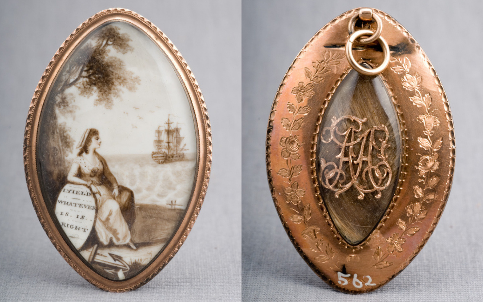 An oval shaped locket. Front side depicts a woman sitting on a beach looking out toward a ship at sea. Back side contains braided human hair and the initials AA under a glass dome.