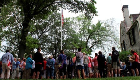 Visitors listen to the Declaration of Independence beneath John Adams's study at Peace field.