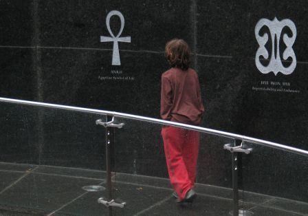 Young visitors looking at symbols that are at found at the African Burial Ground National Monument.