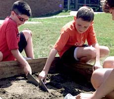 two young boys demonstrate their archeology skills