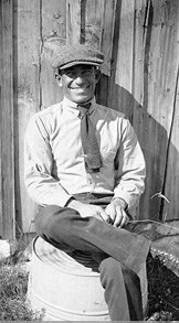 Harold Cook sitting in front of the Bone Cabin on his homestead which included the Fossil Hills. 1921