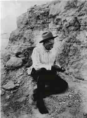 James Cook looking at a fossil.