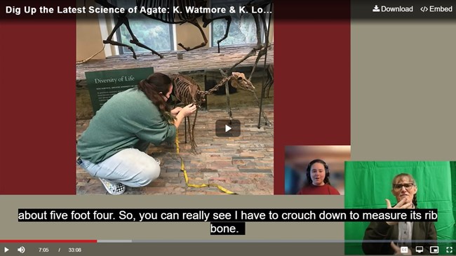 Screenshot of a video clip with captioning and a person in the bottom corner using ASL.