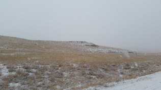 Butte seen through big flakes of snow. Butte seen through big flakes of snow.