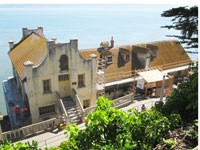 workers on roof of building near water