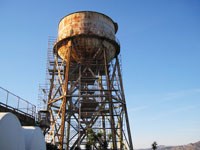 tall rusty metal structure against blue sky