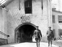 soldiers walking in front of concrete building