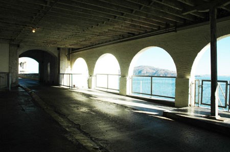 view of walkway with open arches looking to ocean