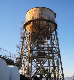 tall rusty metal tower with sky