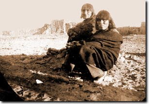 Two Hopi men sitting in desert awaiting arrest.