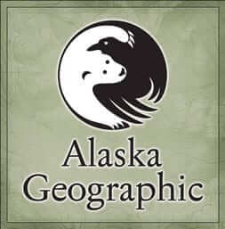 alaska geographic logo with a black raven and white polar bear curled around each other into the shape of a circle.