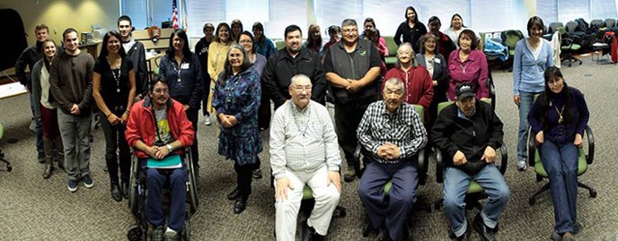 large group of people posing indoors for a photo