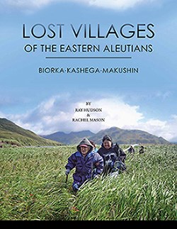 a group of people dressed warmly wade through hip-deep grasses with mountains in the background. Text reads: Lost Villages of the Eastern Aleutions, Biorka, Kashega, Makushin. By Ray Hudson and Rachel Mason.