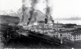 The Navy barracks in Dutch Harbor burn after they were struck by Japanese bombs on 4 June, 1942. The Navy barracks in Dutch Harbor burn after they were struck by Japanese bombs on 4 June, 1942.