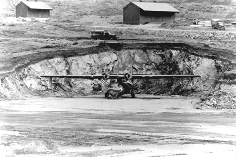 airplane in front of a hillside