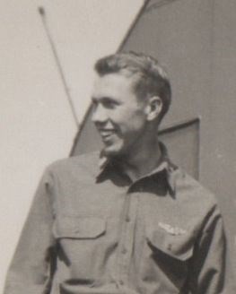 Blue tinted black and white photo of a young man looking to his right