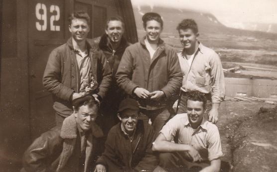 Crewmen in front of a Quonset hut on Attu