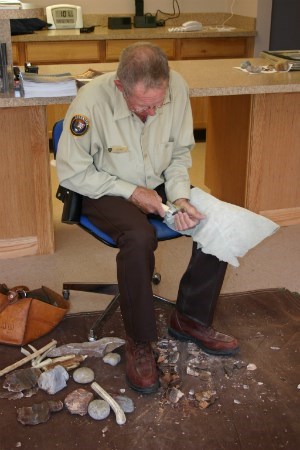 Former VIP and Ranger Ed Day demonstrating the art of flintknapping using the pressure of a deer antler against a piece of Alibates Flint.