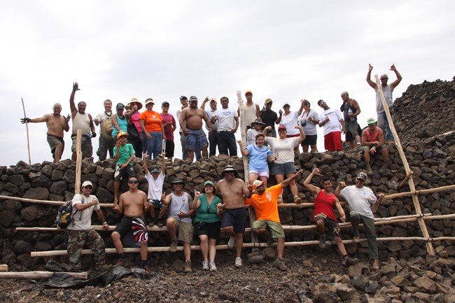 Group of workers pose after construction on a trail site