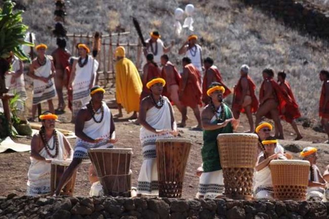 people in traditional Hawaiian costumes at ceremony