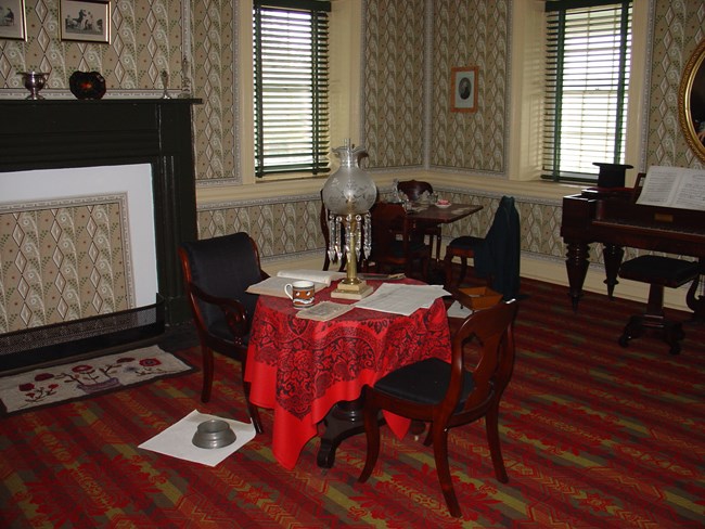Photograph of the reconstructed parlor with period antiques on display