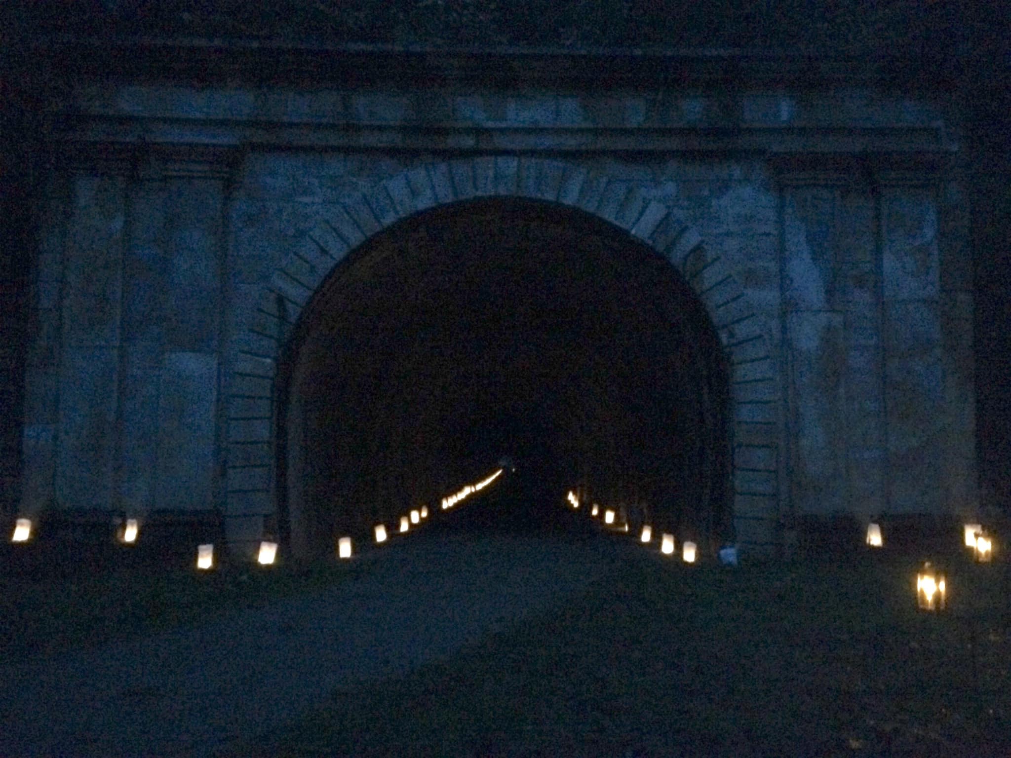 A railroad tunnel with luminaries.