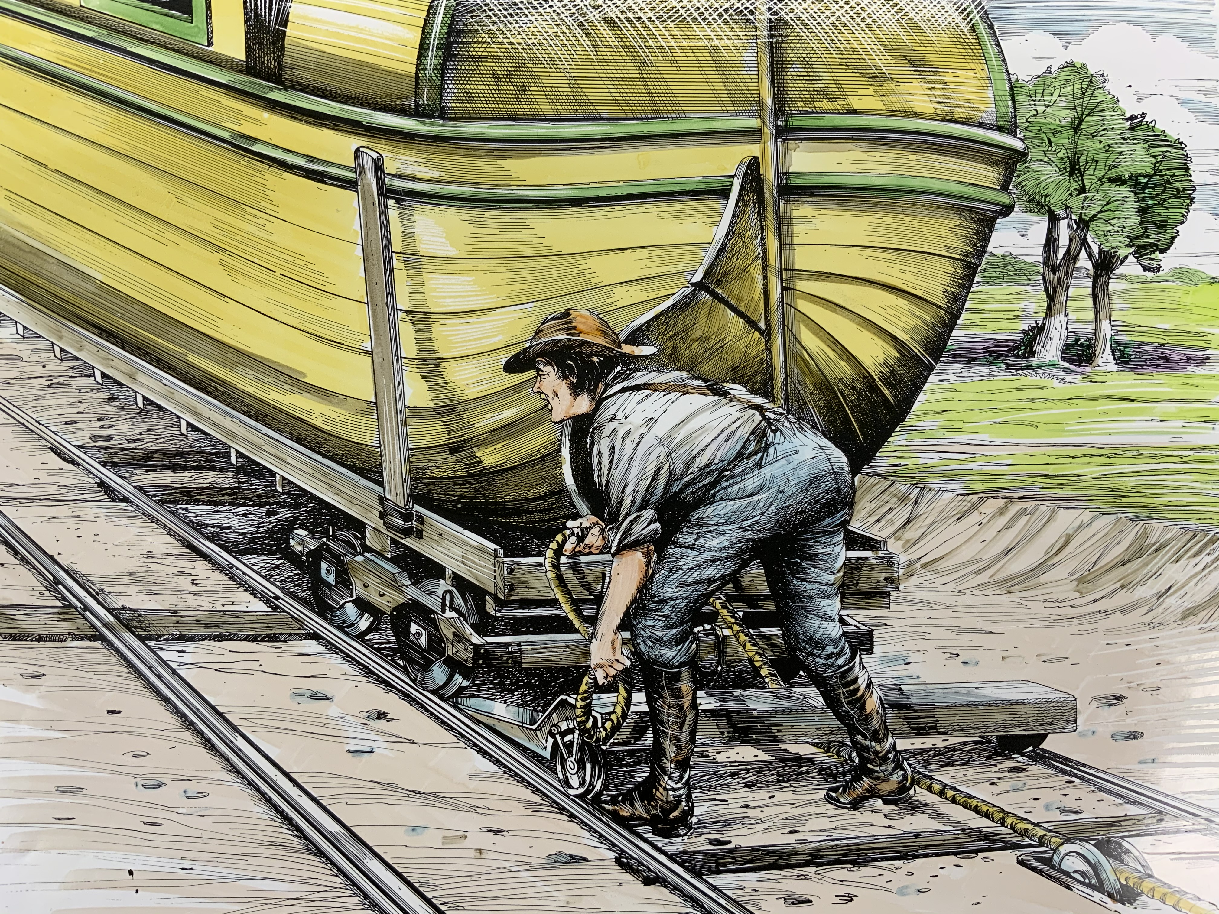 A man hooks up train cars to hemp rope.