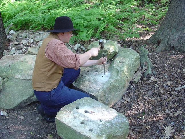 Costumed ranger stonecutting
