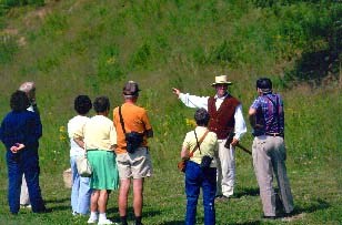 costumed ranger talking with visitors